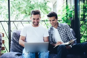 Gay male couple meeting with a surrogacy agency to create their intended parent profile for the surrogate matching process